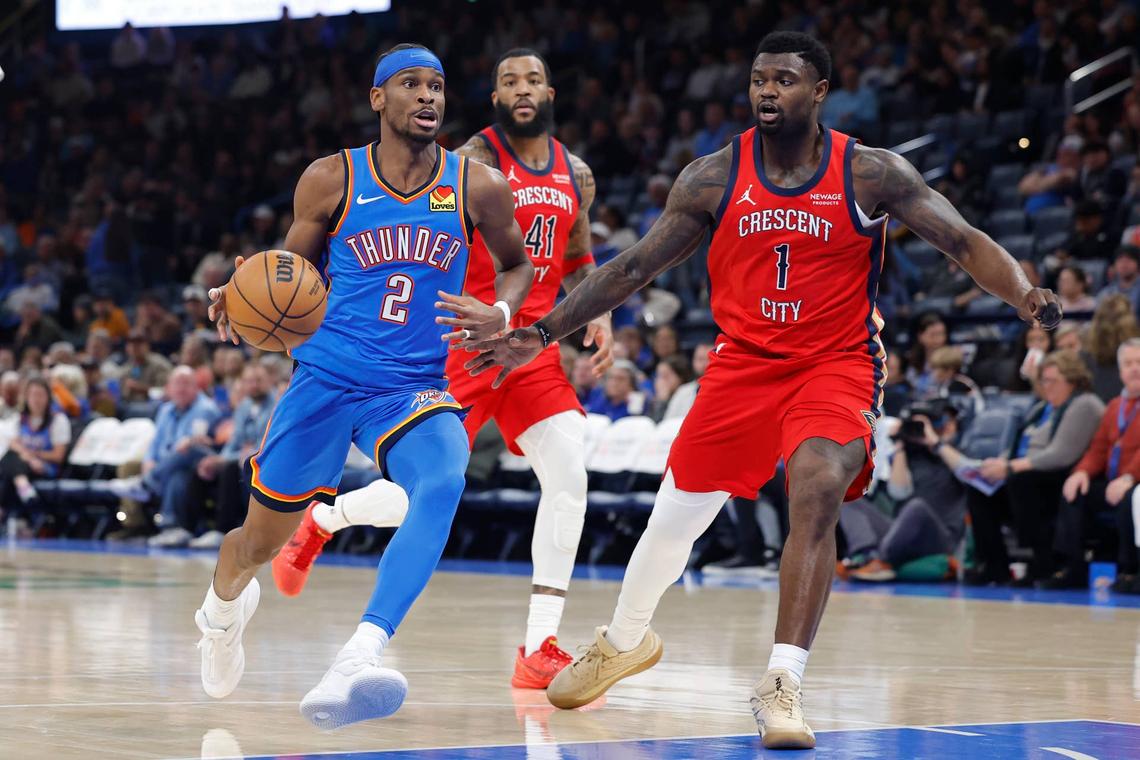  Oklahoma City Thunder guard Shai Gilgeous-Alexander (2) drives to the basket beside New Orleans Pelicans forward Zion Williamson (1) 