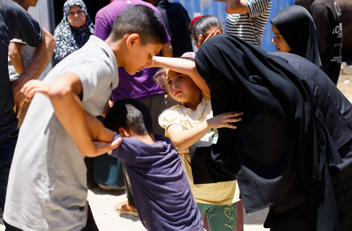 Children of Palestinian Ahmad Abu Heen attend his and his brother's Mahmoud Abu Heen's funeral, after they were killed in an Israeli strike, according to medics, at Al-Awda Hospital in Nuseirat, central Gaza Strip, June 16, 2026. REUTERS/Mahmoud Issa