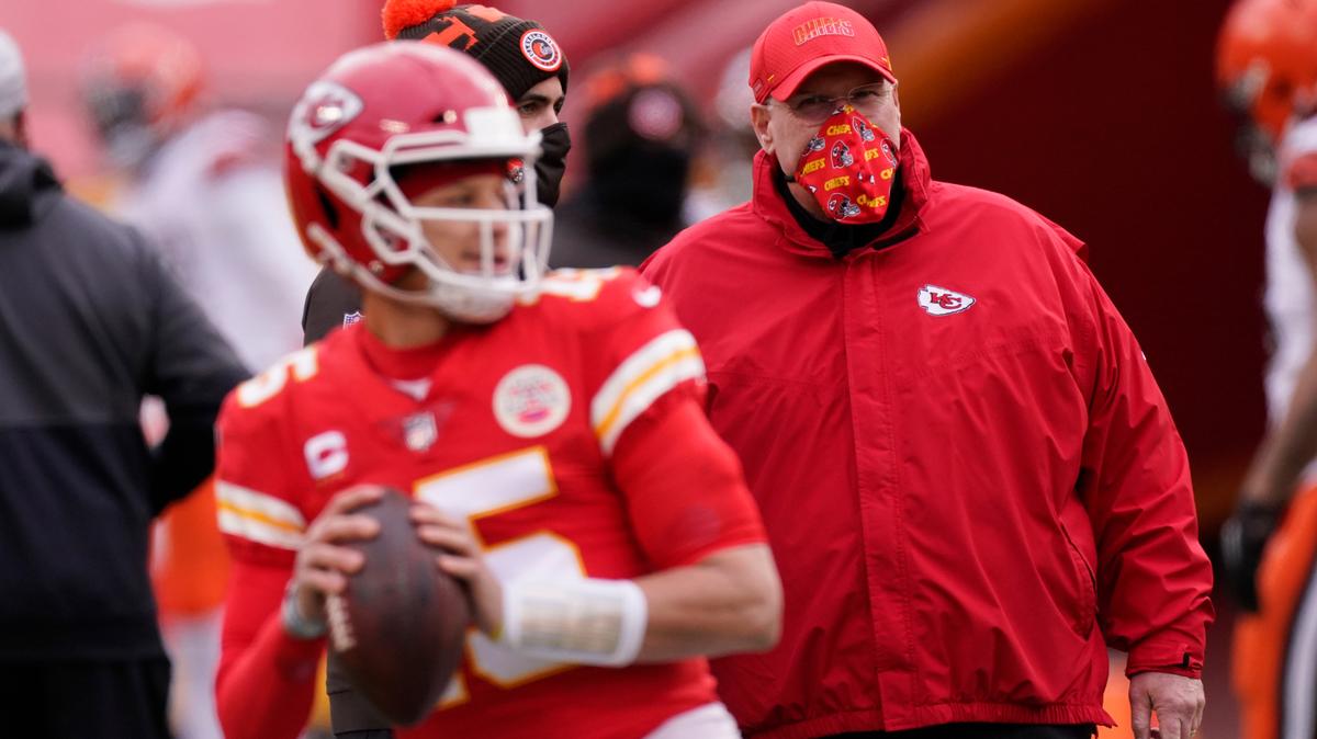 FILE - In this Jan. 17, 2021 file photo, Kansas City Chiefs head coach Andy Reid, right, watches quarterback Patrick Mahomes warm up before an NFL divisional round football game against the Cleveland Browns in Kansas City.
