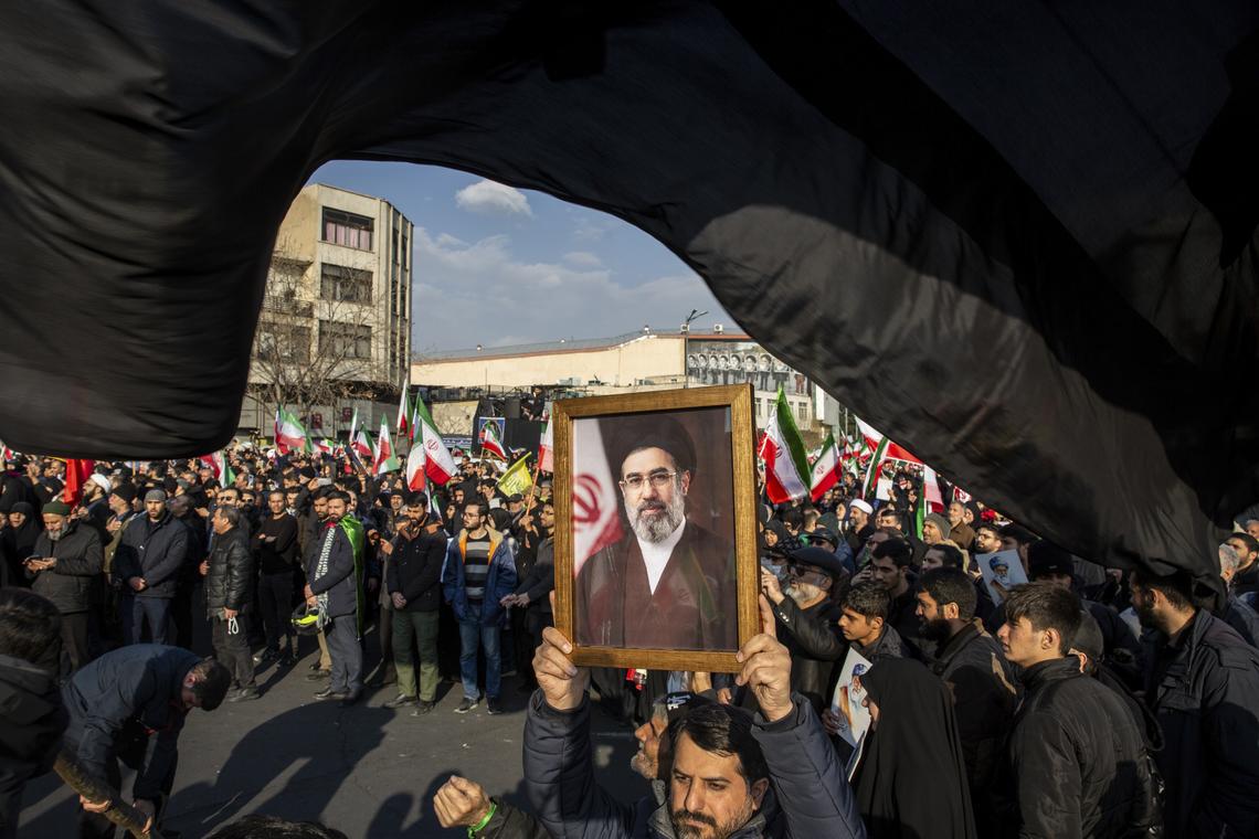 FILE -- A portrait of Mojtaba Khamenei, the son of the recently killed supreme leader Ayatollah Ali Khamenei, as a crowd celebrates his appointment as his father's successor at Enghelab Square in Tehran, Iran, on Monday, March 9, 2026. The killing of Ayatollah Ali Khamenei has ushered in a new form of collective leadership, with more power for the generals of the Revolutionary Guard. (Arash Khamooshi/The New York Times)