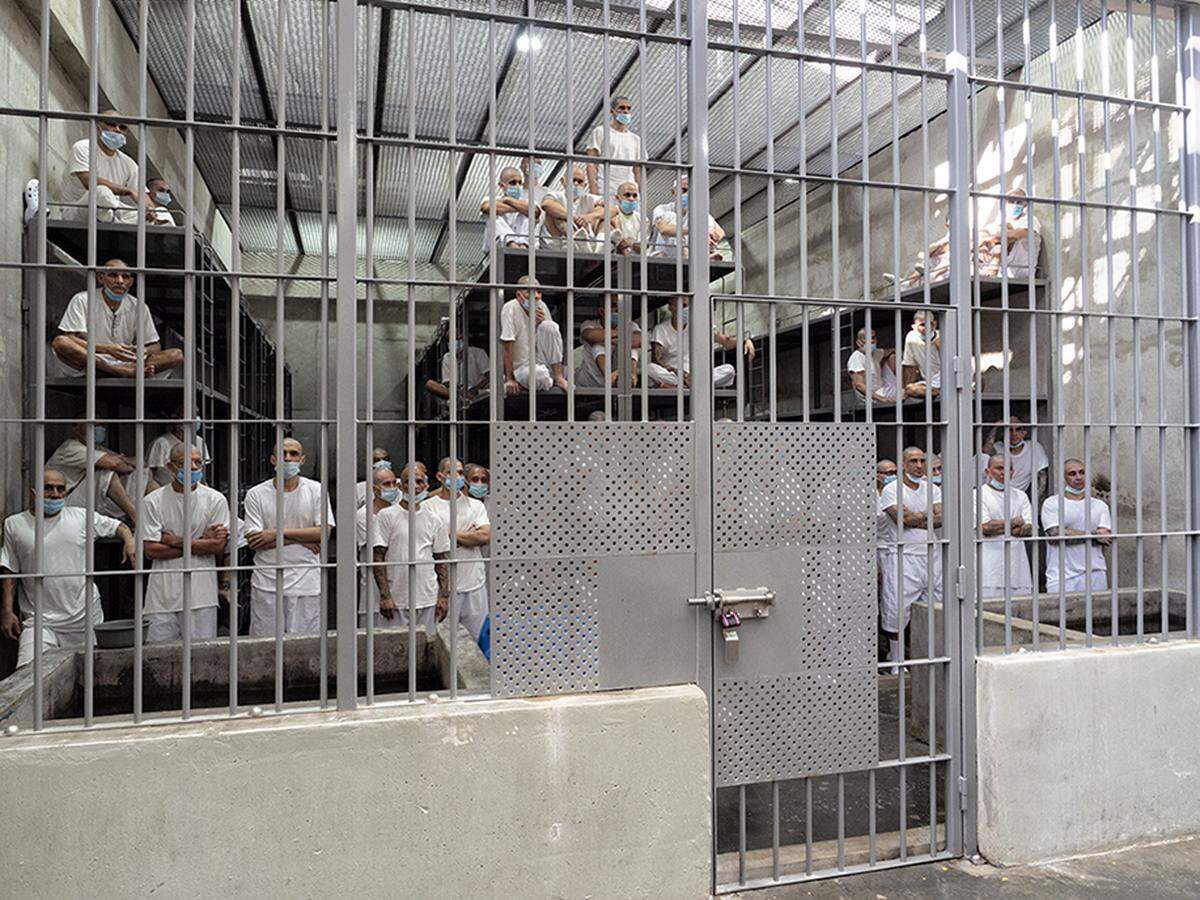 Inmates stand inside their cell at the high-security Center for the Confinement of Terrorism (CECOT) in Tecoluca, El Salvador, on Dec. 10, 2024.