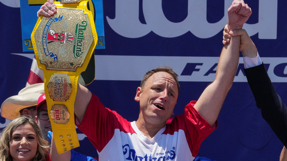 Eating champion Joey Chestnut defends title but blames heat for lower hot-dog tally 