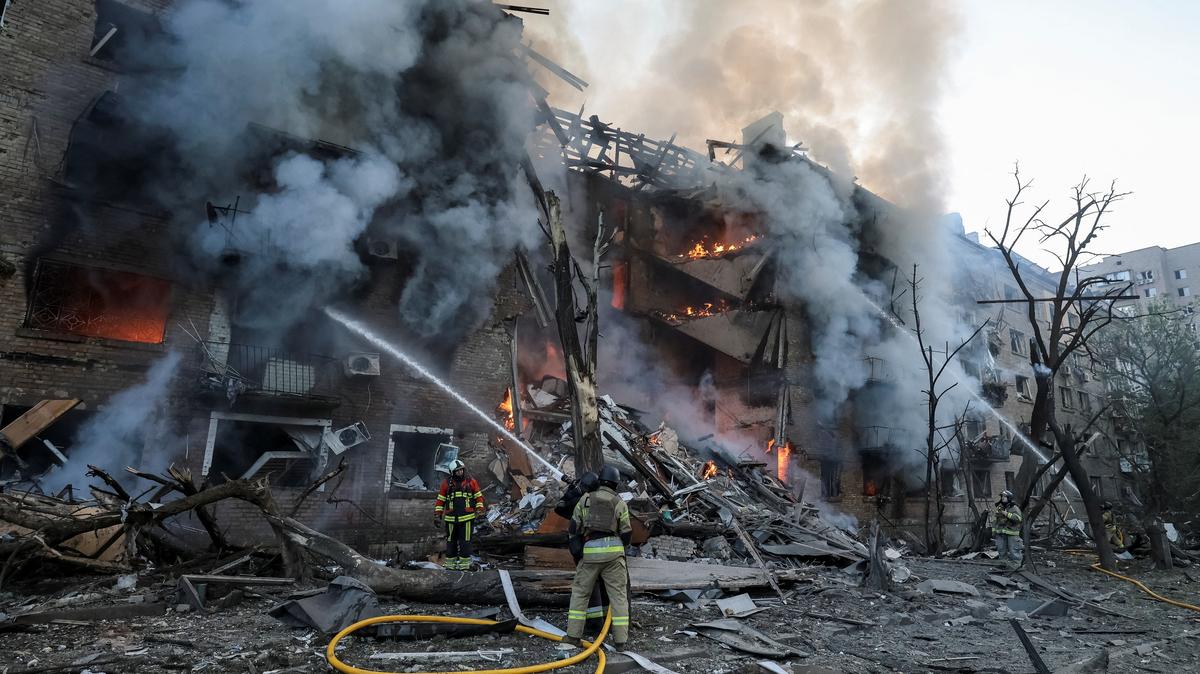 Firefighters work at the site of an apartment building destroyed by a Russian missile and drone strike, amid Russia's attack on Ukraine, in Kyiv, Ukraine, May 24, 2026. REUTERS/Stringer
