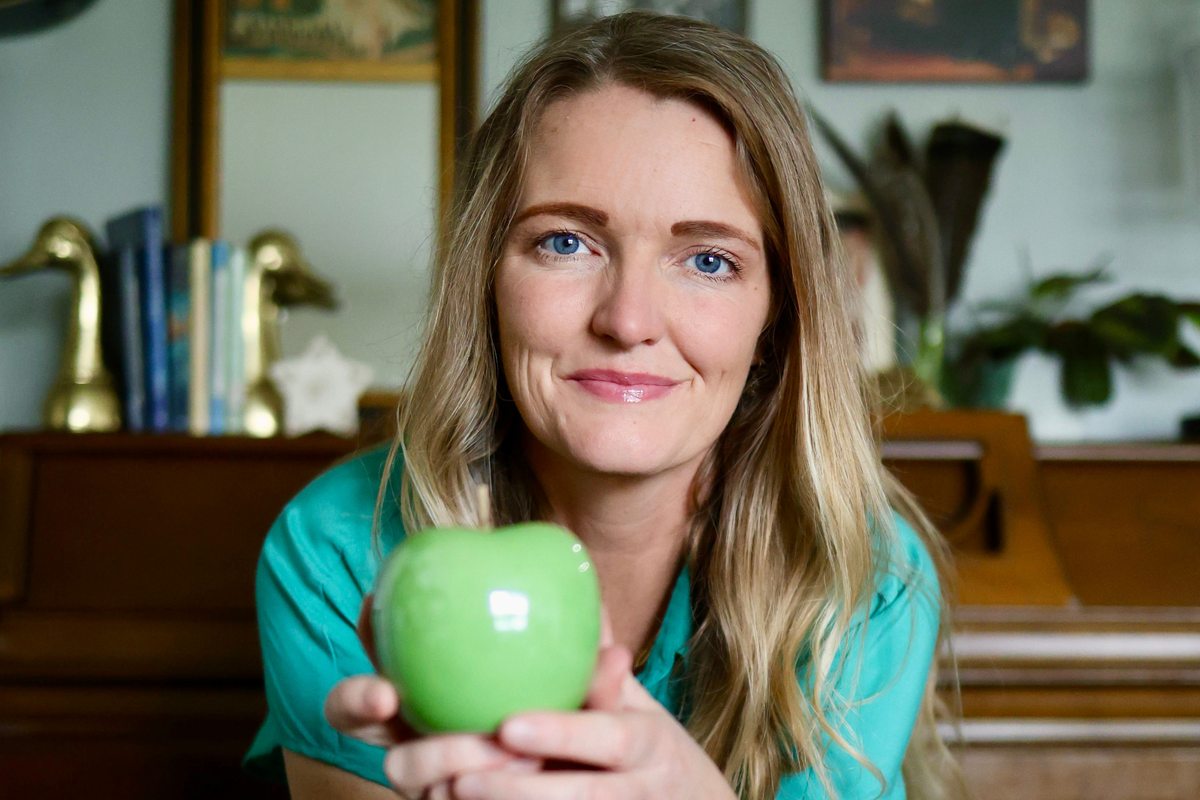  Mom Lauran Newman holds a glass green apple, also known as the “truth apple.” 