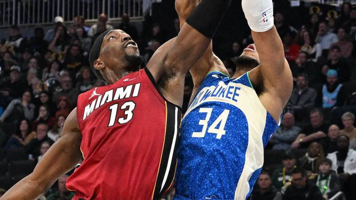  Feb 13, 2024; Milwaukee, Wisconsin, USA; Milwaukee Bucks forward Giannis Antetokounmpo (34) and Miami Heat center Bam Adebayo (13) battle for a rebound in the first half at Fiserv Forum. Mandatory Credit: Michael McLoone-USA TODAY Sports | USA TODAY Sports via Reuters Connect 