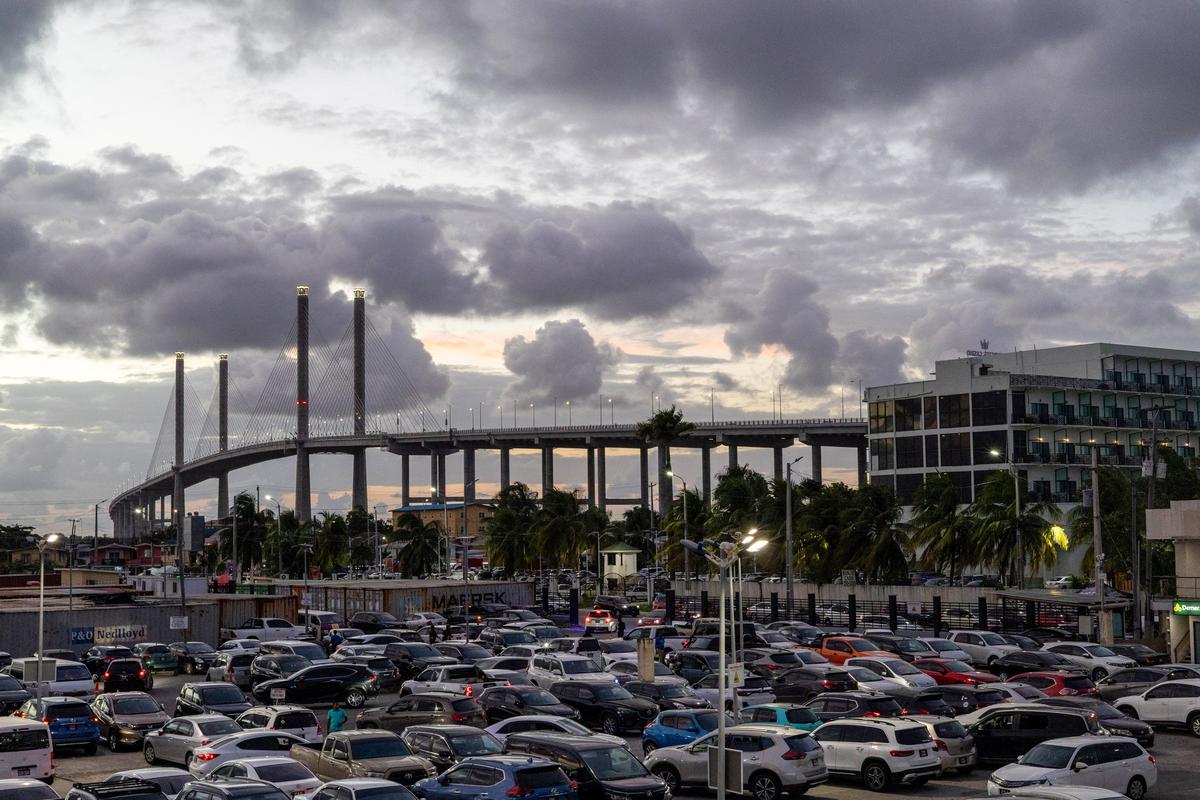 Cars are parked at the Amazonia Mall in front of the Bharrat Jagdeo Demerara River Bridge, which was inaugurated in 2025, as Guyana's fast-growing economy is set to benefit from a reshaped global energy market due to the U.S.-Israeli war on Iran, in Georgetown, Guyana May 9, 2026. REUTERS/Yancey Haywood