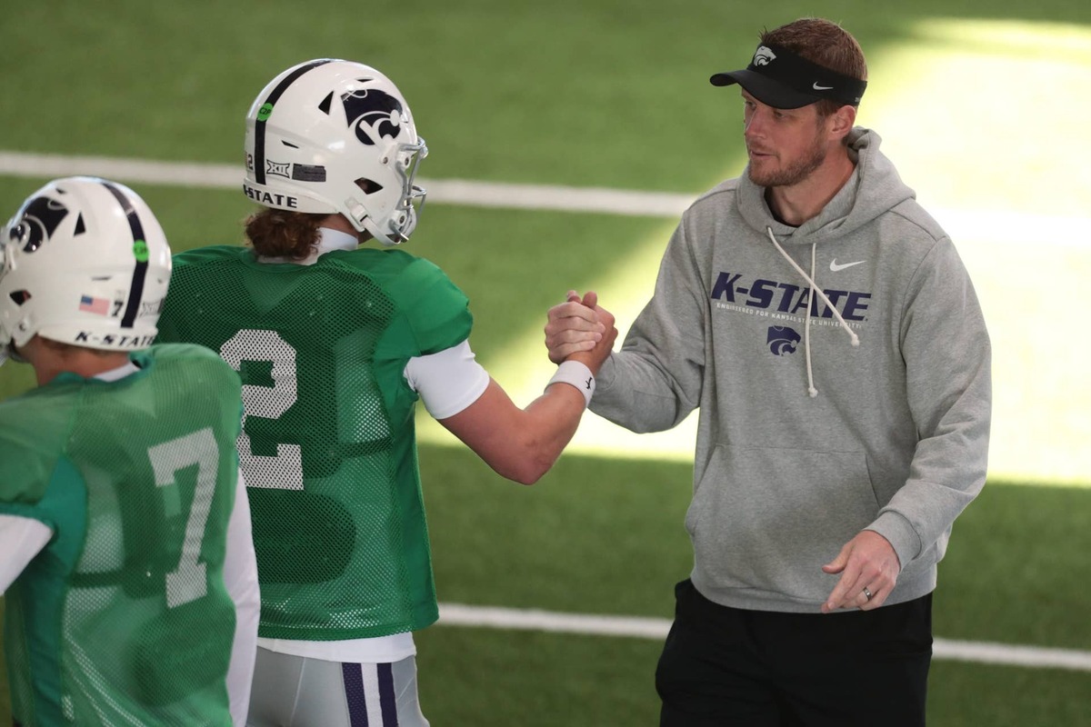  Kansas State head coach Collin Klein slaps hands with senior quarterback Avery Johnson (2) during practice on Tuesday, April 21, 2026. © Evert Nelson/The Capital-Journal / USA TODAY NETWORK via Imagn Images