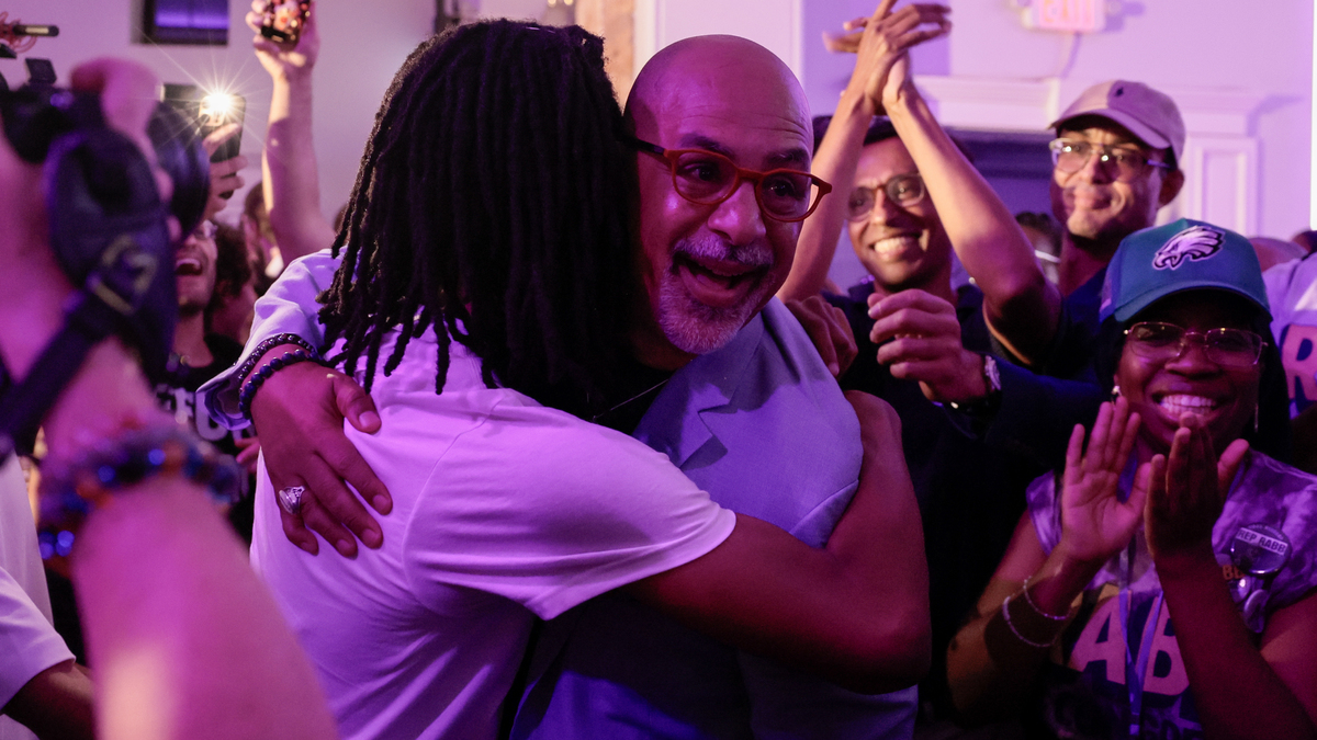 State Rep. Chris Rabb is hugged by his son, Issa Rabb, during his primary election night event at Victorian Banquet Hall on May 19. (Elizabeth Robertson/The Philadelphia Inquirer/TNS)