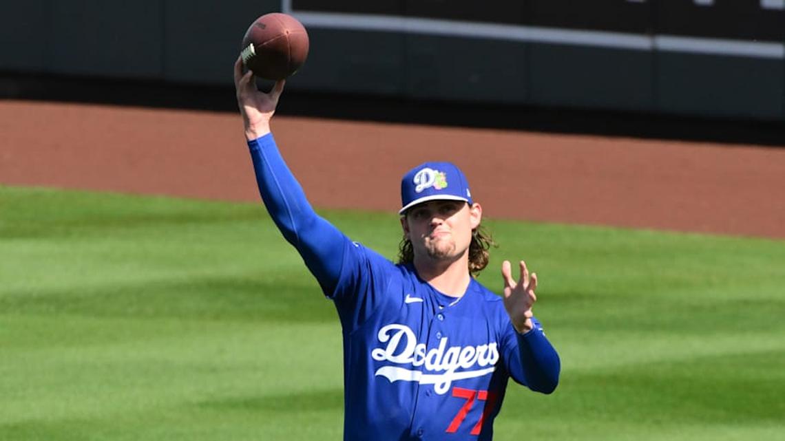  Feb 25, 2026; Salt River Pima-Maricopa, Arizona, USA; Los Angeles Dodgers pitcher River Ryan (77) warms up with a football prior to the game against the Arizona Diamondbacks at Salt River Fields at Talking Stick. | Matt Kartozian-Imagn Images 