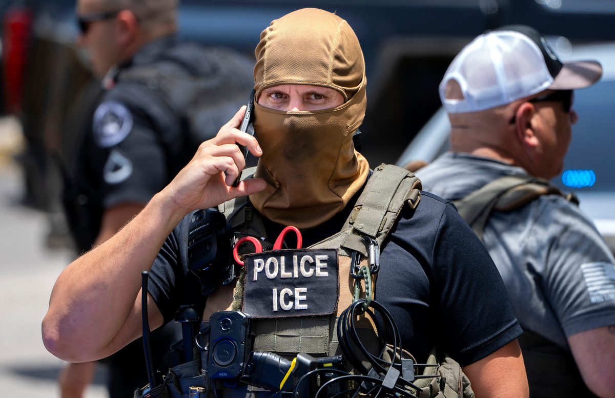 An ICE agent talks on the phone where they arrested Jacob Zapeta Castro at El Quetzal bakery on July 9, 2026 in Lake Worth Beach, Florida. ICE says he was undocumented, had been deported multiple times with a criminal record from a 2012 DUI case in Palm Beach County.