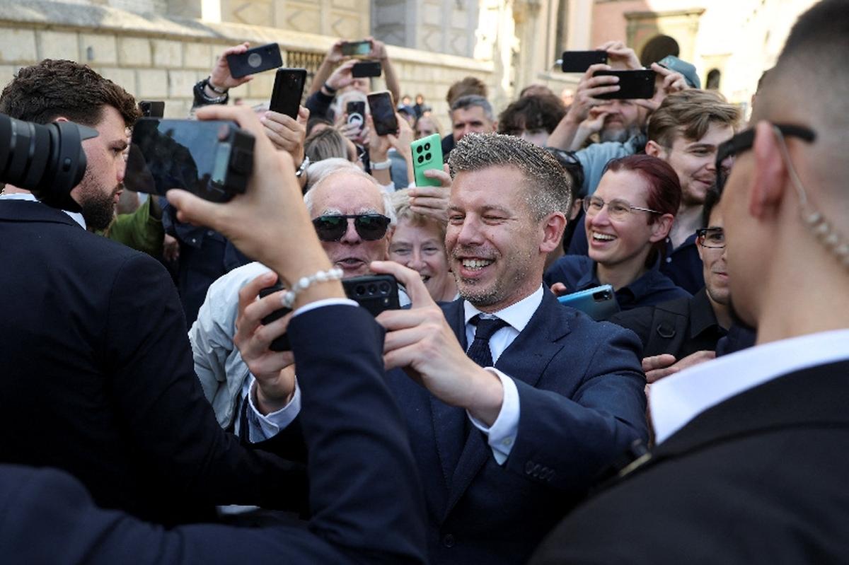 Hungary's Prime Minister Peter Magyar takes a selfie as he walks through the Old Town during his first official visit, in Krakow, Poland, May 19, 2026. REUTERS/Kacper Pempel