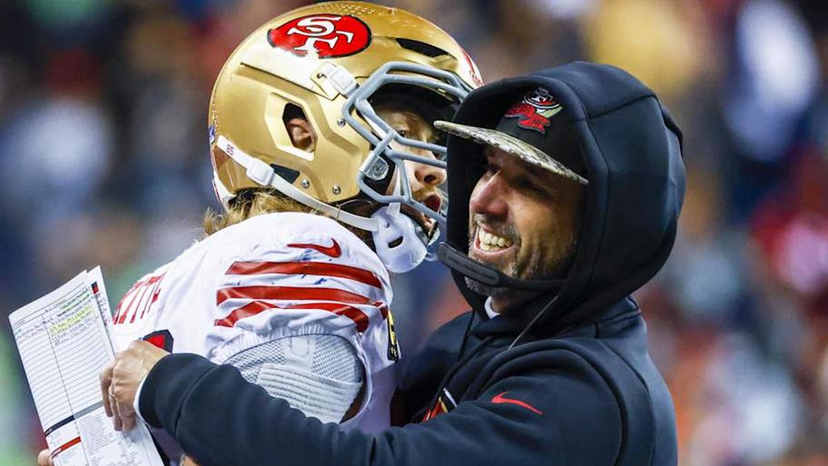  Dec 15, 2022; Seattle, Washington, USA; San Francisco 49ers head coach Kyle Shanahan, right, hugs tight end George Kittle (85) during the late fourth quarter of a 21-13 victory against the Seattle Seahawks at Lumen Field. Mandatory Credit: Joe Nicholson-Imagn Images | Joe Nicholson-Imagn Images 