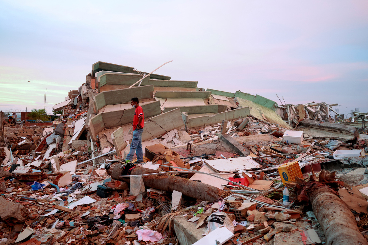 A man stands amid debris at the site of a collapsed building in the aftermath of earthquakes, in La Guaira, Venezuela, June 30, 2026. REUTERS/Ricardo Arduengo
