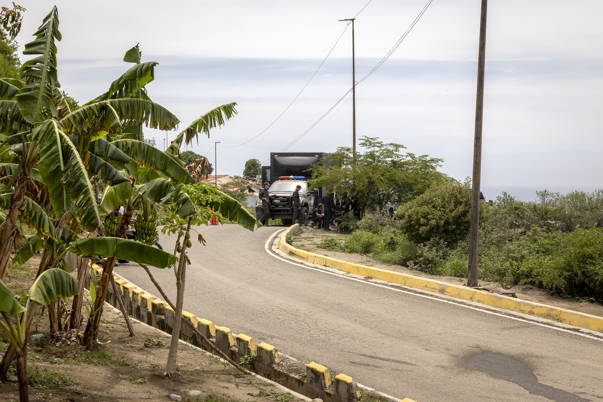 Agents from the government's intelligence service, SEBIN, block access to Hotel Santuario La Llanada, where deportees were held, in La Guaira, Venezuela, on Tuesday, June 30, 2026. The SEBIN, an arm of Venezuela's repressive regime, has a long history of political suppression and human rights violations, from torture to arbitrary detentions. At least one earthquake survivor told The New York Times that the SEBIN had threatened him to remain quiet about what had happened at the facility. (Fabiola Ferrero/The New York Times)