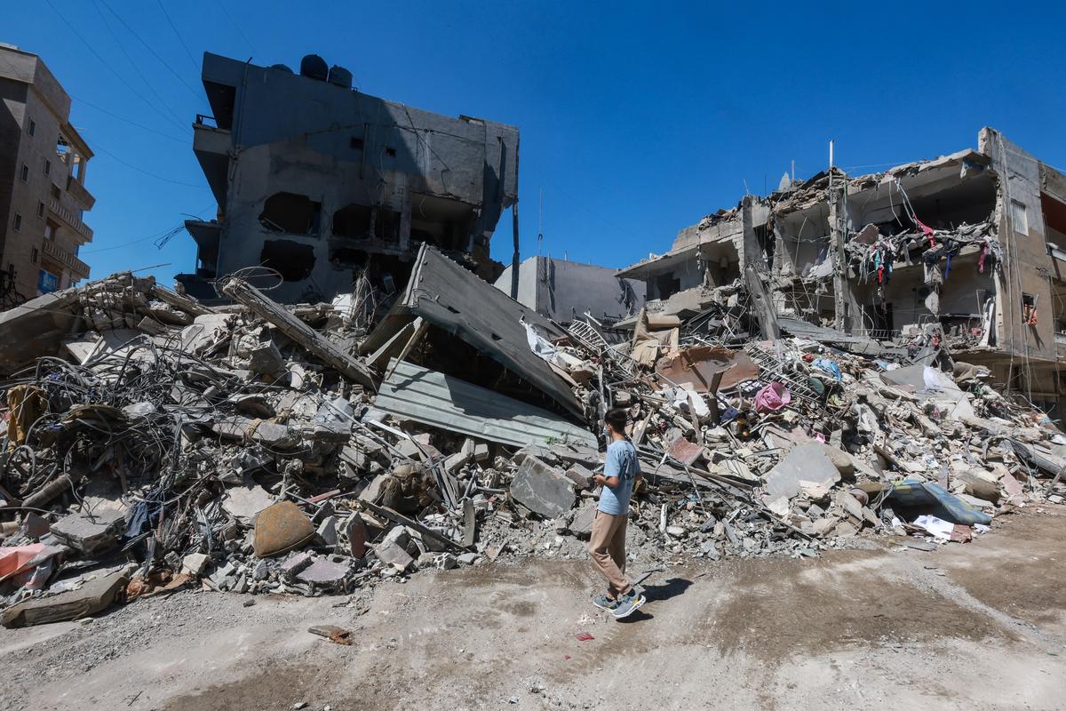 A boy inspects the damage at the site of an overnight Israeli strike in the southern city of Tyre, Lebanon, May 23, 2026. REUTERS/Aziz Taher