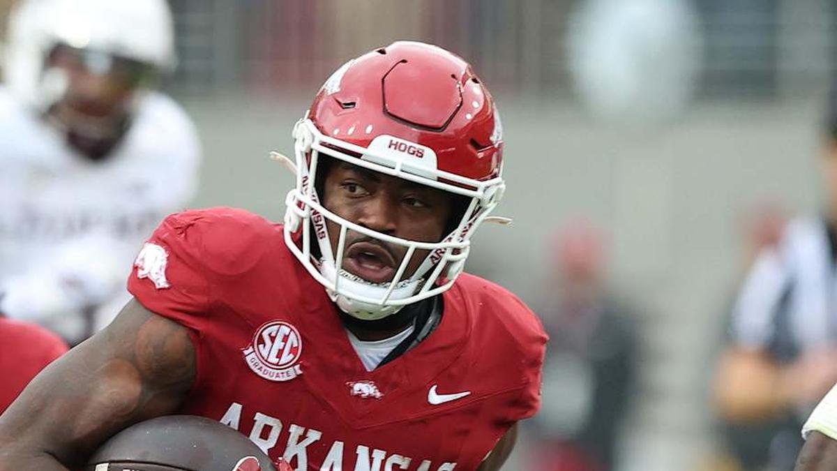  Oct 18, 2025; Fayetteville, Arkansas, USA; Arkansas Razorbacks running back Mike Washington Jr (4) rushes in the second quarter as Texas A&M Aggies cornerback Tyreek Chappell (7) and safety Dalton Brooks (25) defend at Donald W. Reynolds Razorback Stadium. Mandatory Credit: Nelson Chenault-Imagn Images | Nelson Chenault-Imagn Images 