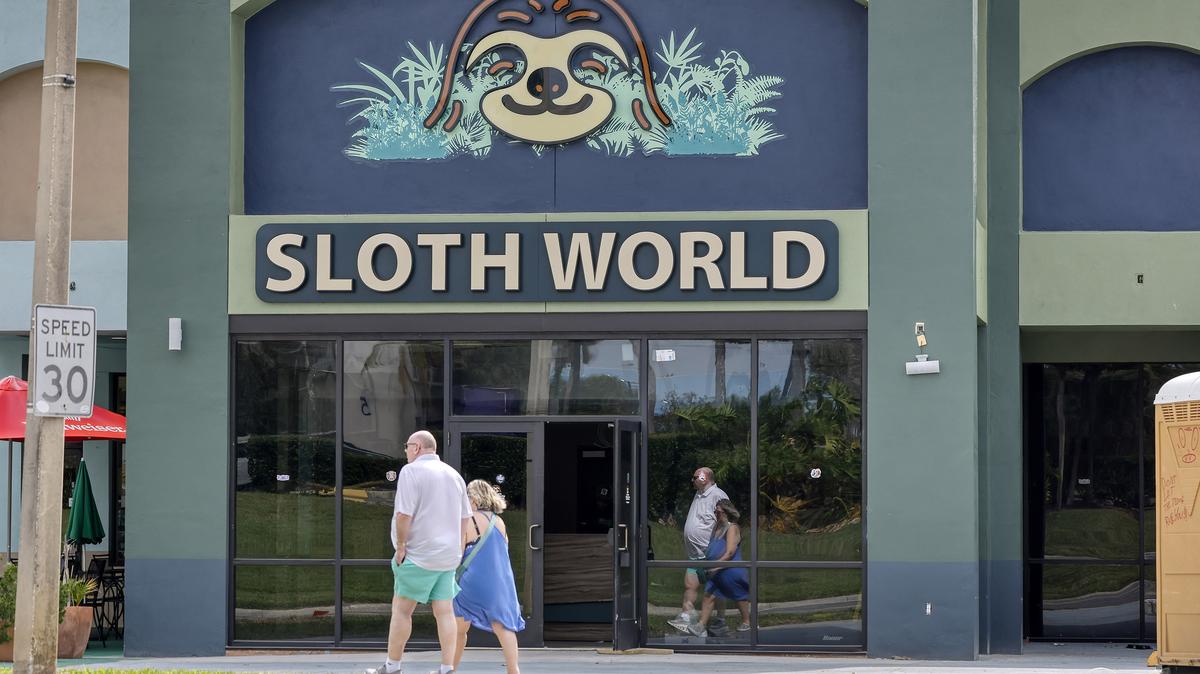 Pedestrians walk past Sloth World, under construction along International Drive, on April 20, 2026, in Orlando, Florida. (Ricardo Ramirez Buxeda/Orlando Sentinel/TNS)