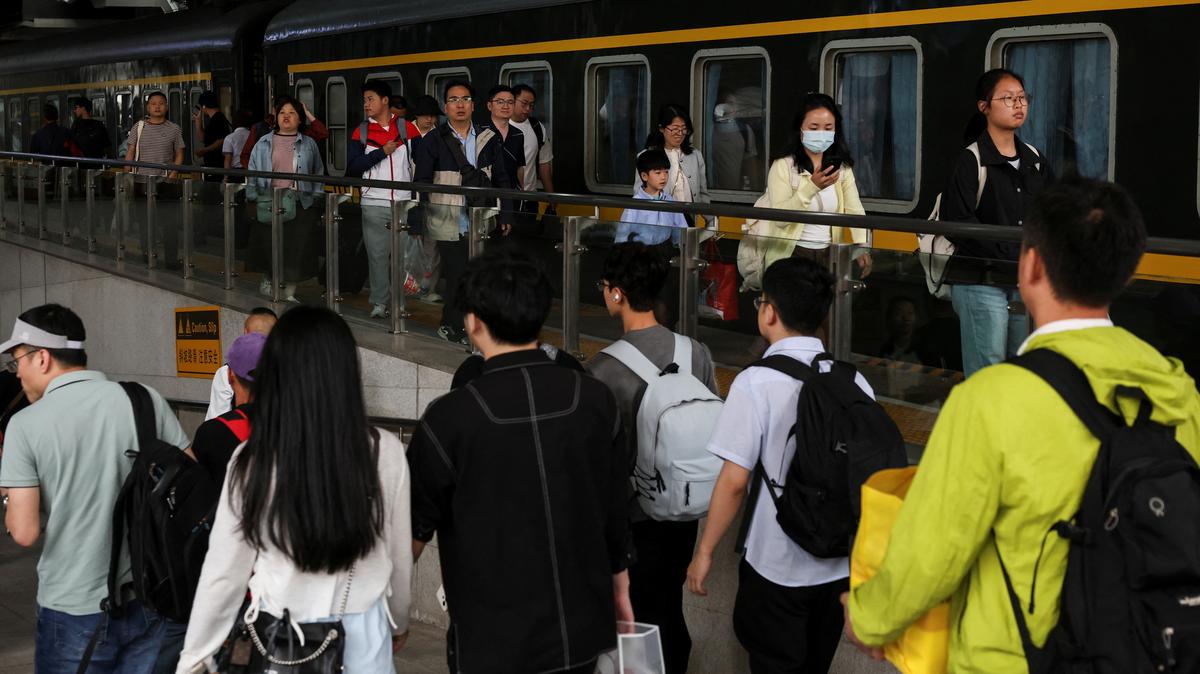 People walk on a platform after disembarking from a train at Shanghai South Railway Station during the five-day Labour Day holiday in Shanghai, China May 4, 2025. REUTERS/Go Nakamura