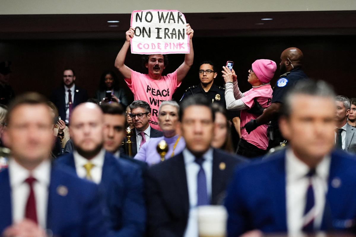 A protester holds a banner opposing the war with Iran during U.S. Defense Secretary Pete Hegseth's opening remarks at a Senate Armed Services Committee hearing on U.S. President Donald Trump's FY2027 budget request for the Department of Defence on Capitol Hill in Washington, D.C., April 30. REUTERS/Eric Lee