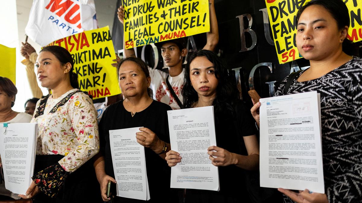 FILE PHOTO: Kristina Conti, a human rights lawyer, representing victims of the war on drugs, along with Sheerah Escudero and Dahlia Cuartero, relatives of drug war victims, and Katherine Panguban of the National Union of People's Lawyers, representing the victims, show their affidavits and a letter to the National Bureau of Investigation requesting a probe into the online harassment they have received following the arrest of former Philippine President Rodrigo Duterte, at the National Bureau of Investigation in Pasay City, Philippines, April 4, 2025. REUTERS/Eloisa Lopez/File Photo