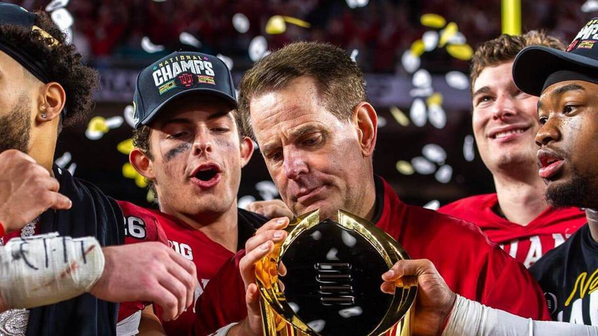  Indiana Head Coach Curt Cignetti prepares to lift the trophy on the podium after the College Football Playoff National Championship college football game at Hard Rock Stadium in Miami Gardens on Monday, Jan. 19, 2026. | Rich Janzaruk/Herald-Times / USA TODAY NETWORK via Imagn Images 