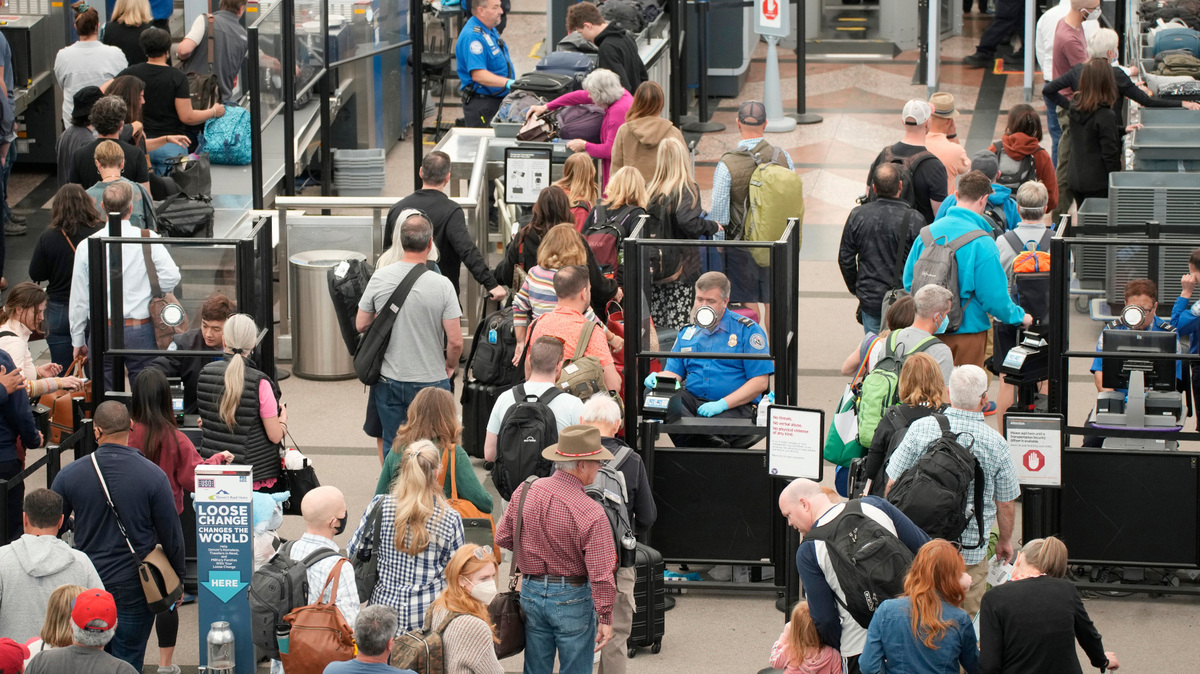 Travelers move through security at Denver International Airport on Thursday, May 26, 2022. Airline passengers are not only facing sticker shock this Memorial Day weekend, they’re battling a pileup of flight cancellations. More than 1,000 were canceled as of Saturday afternoon, according to FlightAware after 2,300 Friday.