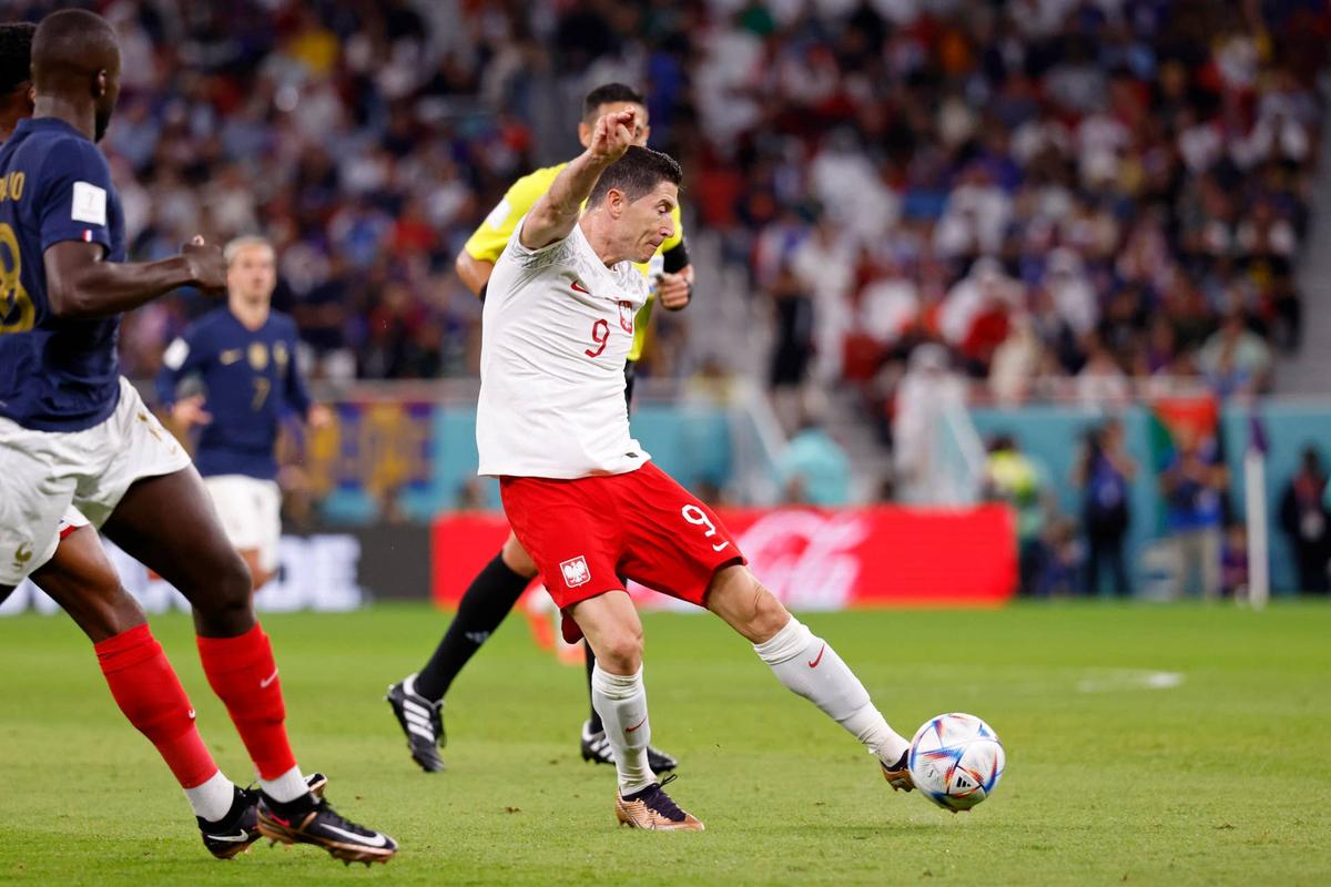  Poland forward Robert Lewandowski shoots the ball against France during the first half of a round of sixteen match in the 2022 FIFA World Cup. Yukihito Taguchi-USA TODAY Sports