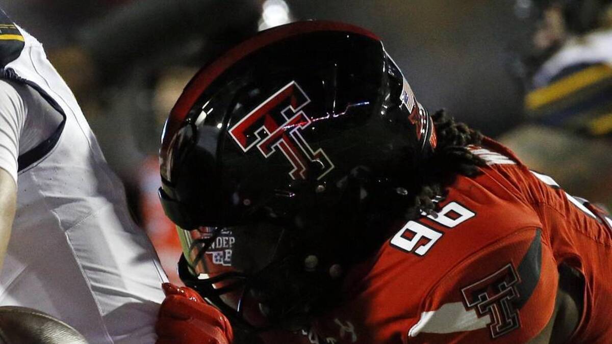  Dec 16, 2023; Shreveport, LA, USA; Texas Tech Red Raiders defensive linemen Amier Washington (96) forces California Golden Bears quarterback Fernando Mendoza (15) to fumble during the first half at Independence Stadium. Mandatory Credit: Petre Thomas-Imagn Images | Petre Thomas-Imagn Images 