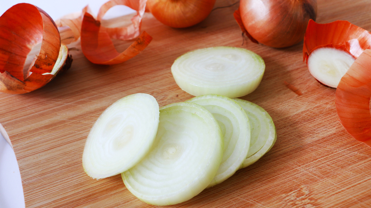 Bombay Onion cut into ring on wooden chopping board background