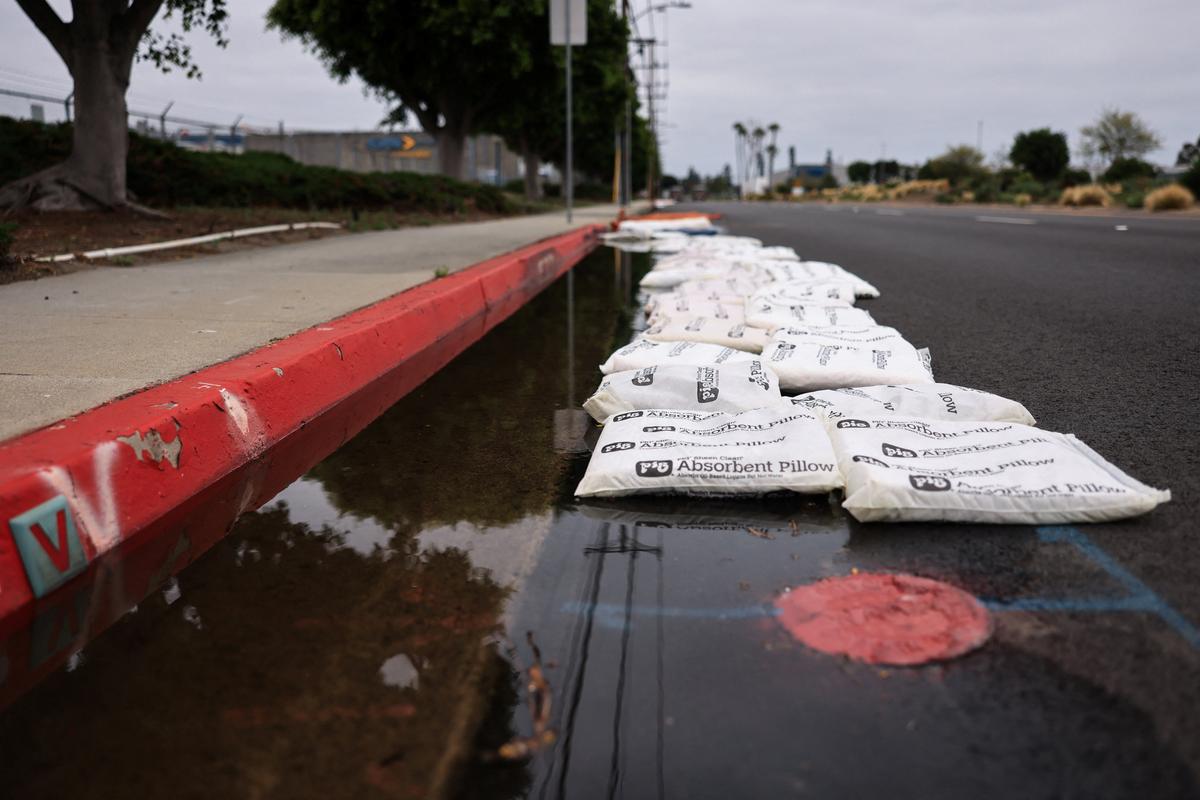 Absorbent pillows are used along a road during a chemical incident involving a leaking tank of methyl methacrylate, a flammable liquid used in the aerospace industry, forcing an evacuation in the surrounding area, in Garden Grove, California, U.S., May 23, 2026. REUTERS/David Swanson