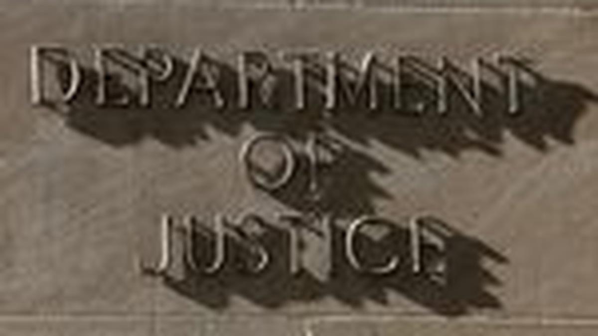 FILE PHOTO: A sign for the U.S. Department of Justice in Washington, D.C., April 6, 2026. REUTERS/Kevin Lamarque/File Photo