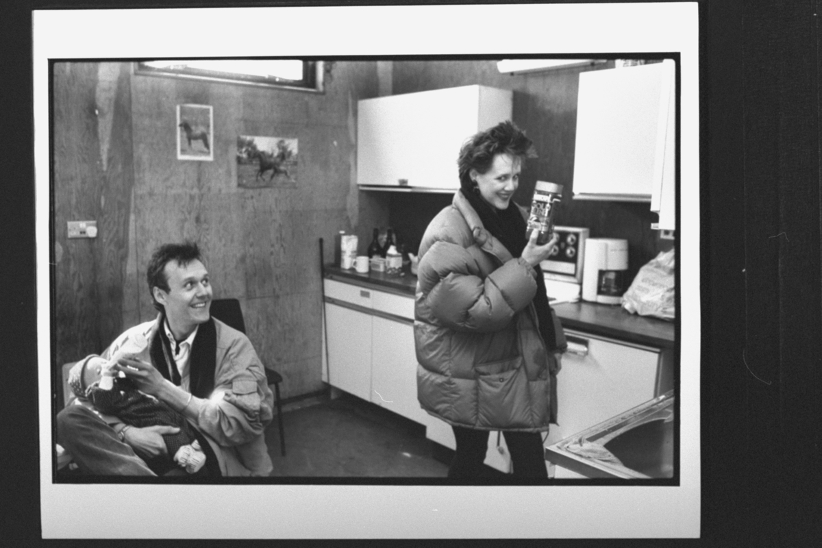 Anthony Head bottle-feeding baby daughter Daisy as his partner Sarah Fisher holds up a jar of Gold Blend coffee; Head did their popular TV commercials in the UKan Cook/Getty Images