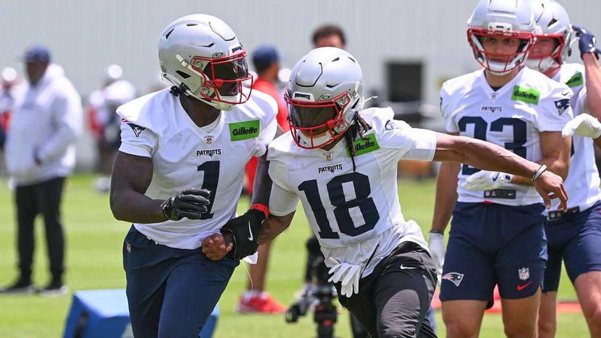  Jun 2, 2026; Foxborough, MA, USA; New England Patriots wide receiver Kyle Williams (18) covers wide receiver A.J. Brown (1) during the team's OTA at Gillette Stadium. Mandatory Credit: Eric Canha-Imagn Images | Eric Canha-Imagn Images 