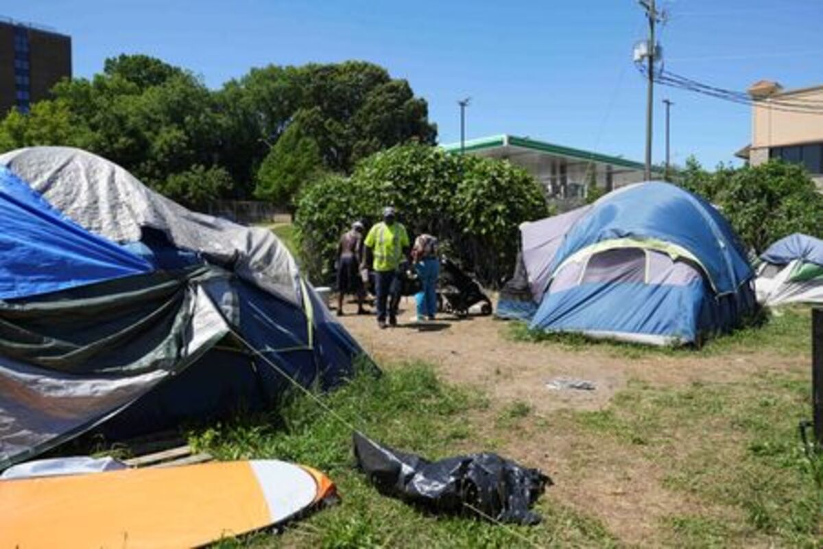 People stand by tents in a homeless encampment in the vicinity of Mercedes-Benz Stadium, temporarily renamed Atlanta Stadium, that will host upcoming FIFA World Cup matches in Atlanta, Georgia, U.S., May 15, 2026.   REUTERS/Megan Varner