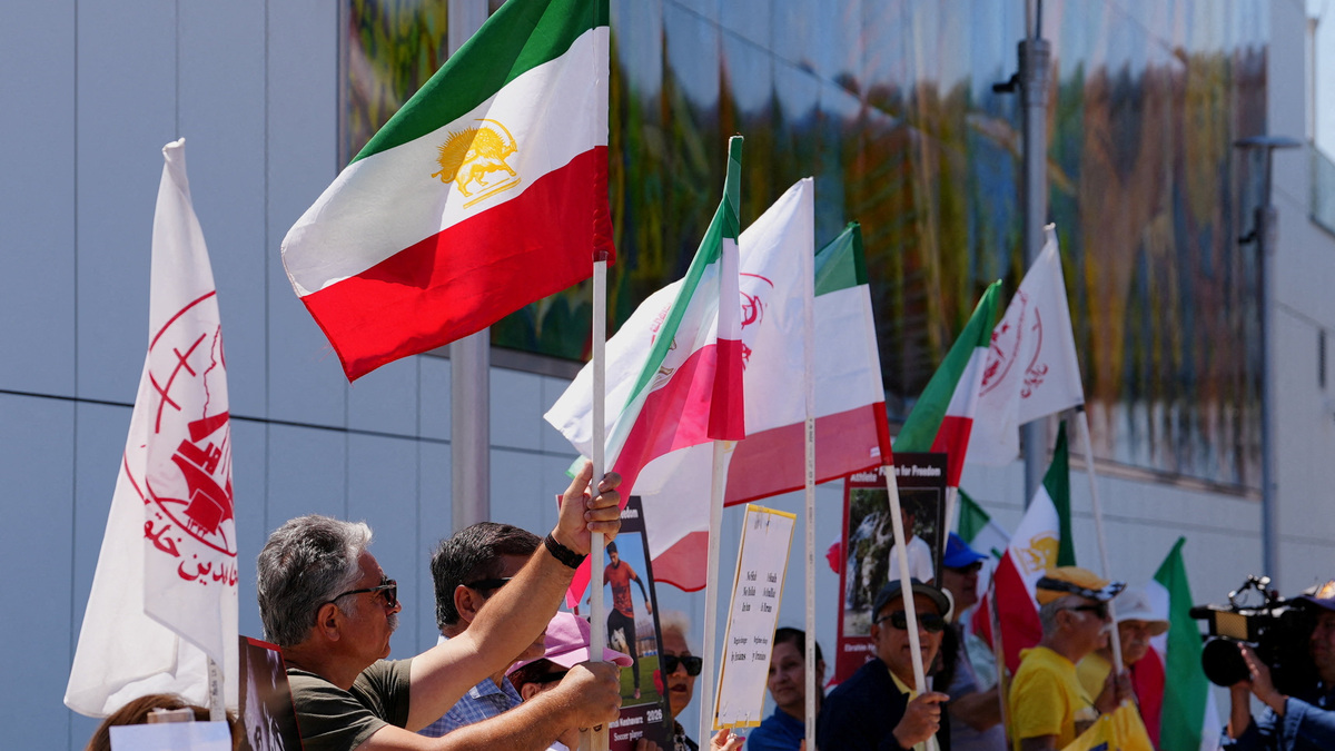 People wave flags during a demontration calling on FIFA to suspend or expel Iran from international football, complaining about the country's violations of FIFA's statutes of athletes' rights, ahead of Iran's first match during the FIFA World Cup 2026, near SoFi Stadium in Inglewood, California, U.S., June 14, 2026. REUTERS/Arafat Barbakh