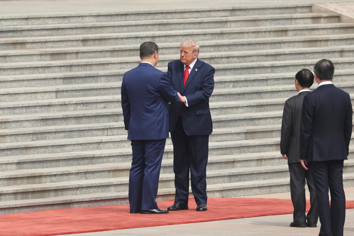 Chinese President Xi Jinping greets U.S. President Donald Trump during a welcome ceremony at the Great Hall of the People, in Beijing, China, May 14, 2026. REUTERS/Maxim Shemetov/Pool