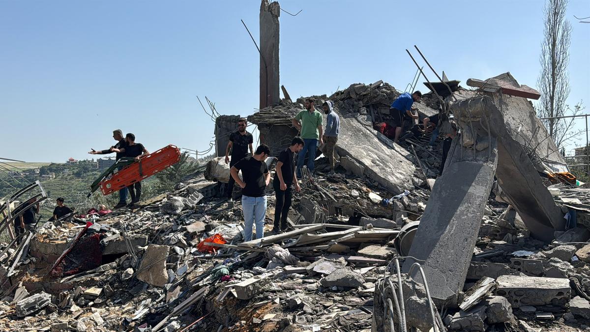 Emergency responders assisted by other people and heavy machinery inspect the site of an Israeli strike in Saksakiyeh, Lebanon, May 9, 2026. Picture taken with a mobile phone. REUTERS/Stringer