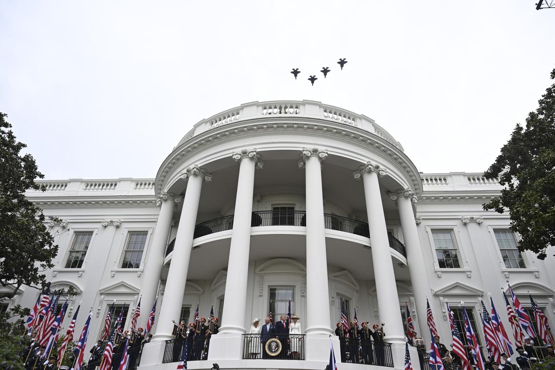 From right: first lady Melania Trump, President Donald Trump, King Charles III, and Queen Camilla as F-35 fighter jets pass overhead from a balcony of the White House during an arrival ceremony in Washington, on Tuesday, April 28, 2026. (Kenny Holston/The New York Times)