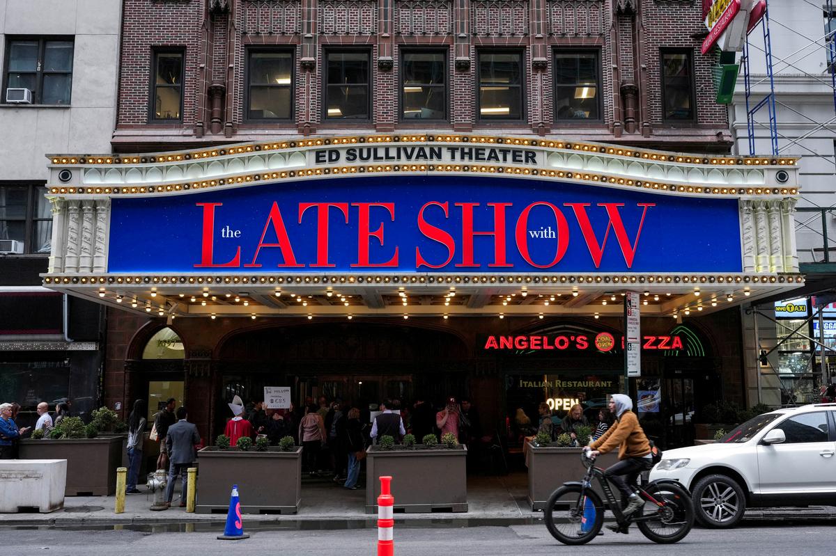 FILE PHOTO: People gather outside of the Ed Sullivan Theater before the taping of the final episode of the "The Late Show" with Stephen Colbert, in New York City, U.S., May 21, 2026. REUTERS/Adam Gray/File Photo
