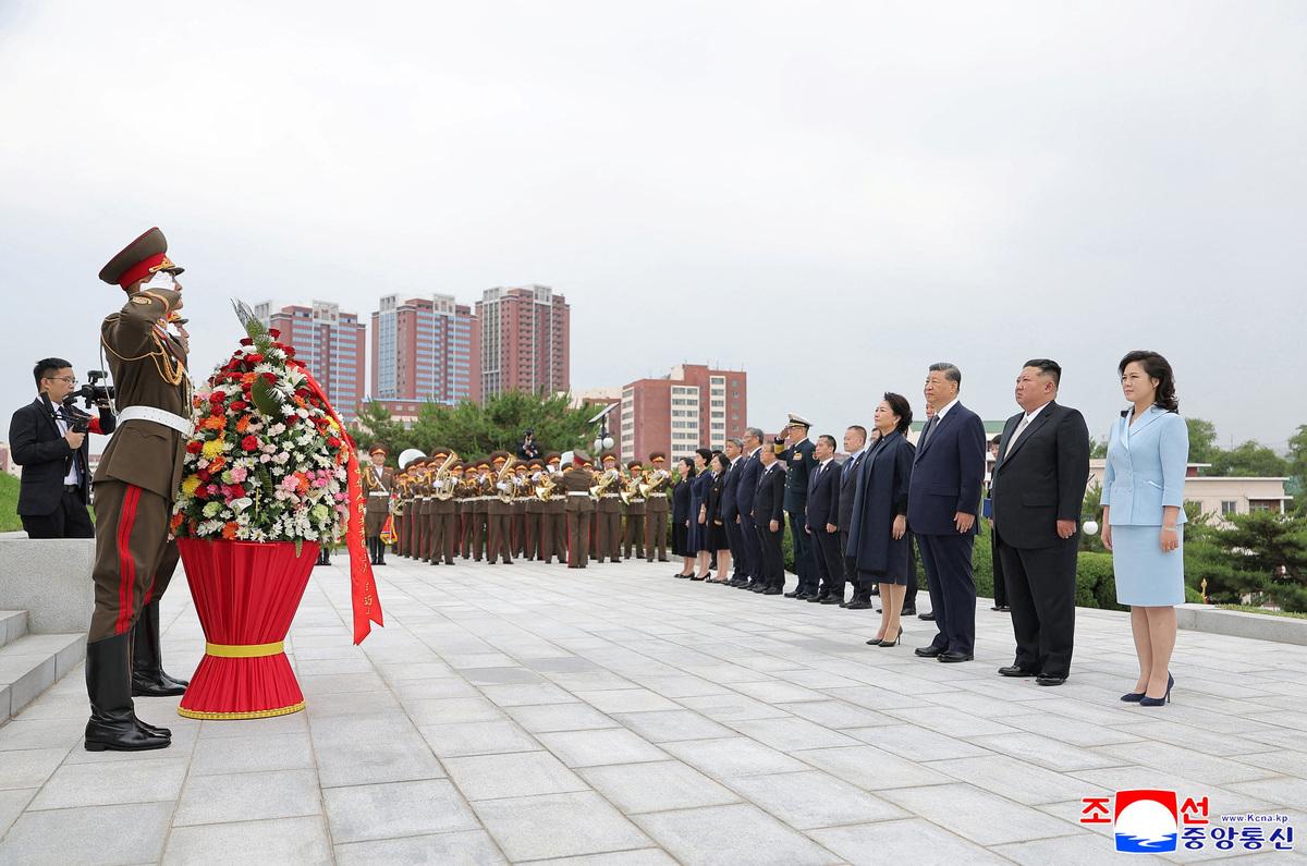 Chinese President Xi Jinping and his wife Peng Liyuan stand with North Korean leader Kim Jong Un and his wife Ri Sol Ju, as they visit the Friendship Tower to lay a flower basket, in Pyongyang, North Korea, June 9, 2026, in this picture released June 10, 2026. KCNA via REUTERS
