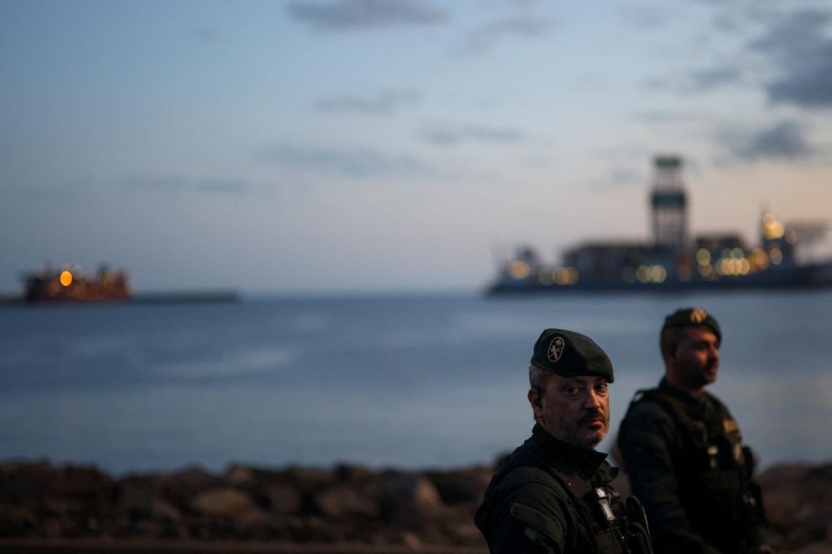 Members of the Spanish Civil Guard stand guard at the port of Granadilla de Abona, where the cruise ship MV Hondius is expected to dock after being affected by a hantavirus outbreak, in Tenerife, Spain, May 9, 2026. REUTERS/Hannah McKay