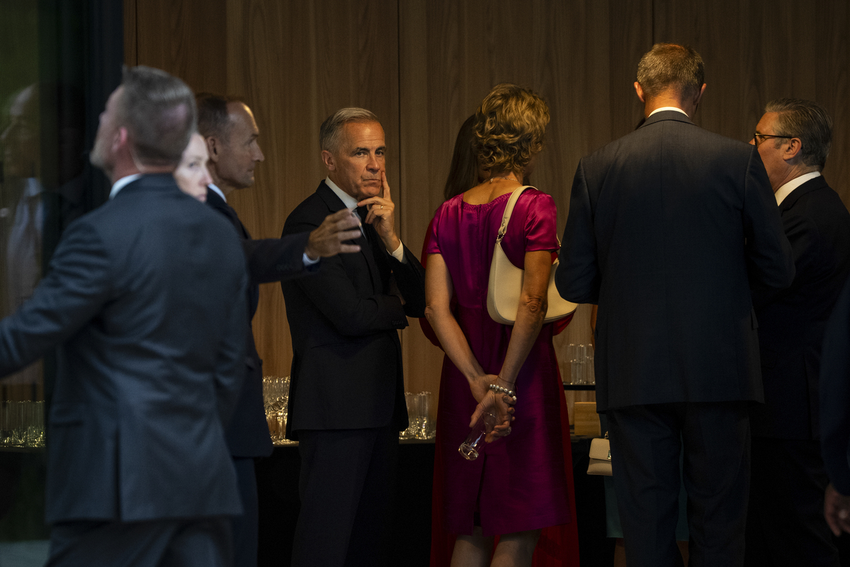 Prime Minister Mark Carney waits for a group photo session befofre a cultural performance at the G7 Summit in Evian-les-Bains, France, June 16, 2026. (Haiyun Jiang/The New York Times)