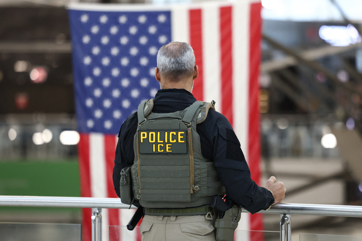  A U.S. Immigration and Customs Enforcement (ICE) stands watch at a security checkpoint at John F. Kennedy International Airport in New York, on March 23, 2026. 
