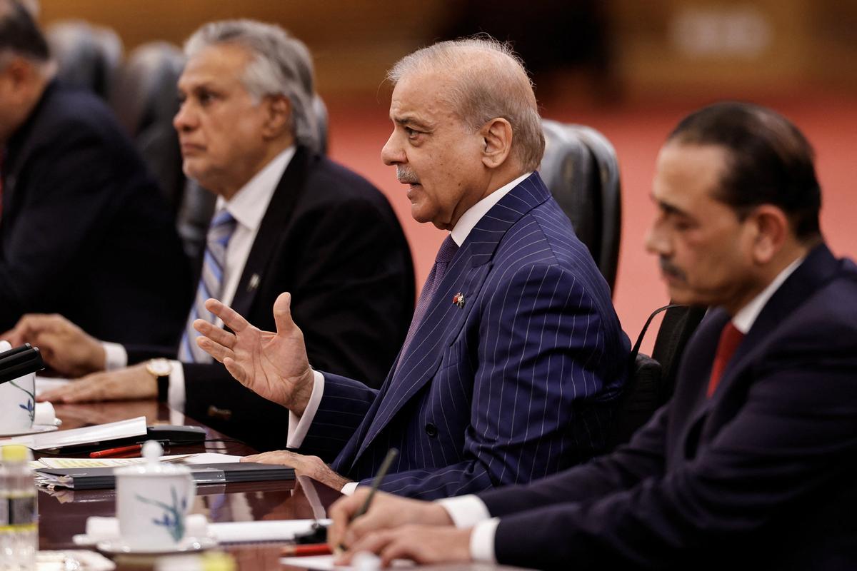Pakistan's Prime Minister Shehbaz Sharif, Deputy Prime Minister Ishaq Dar, army chief Asim Munir attend a meeting with Chinese President Xi Jinping at the Great Hall of the People, in Beijing, China May 25, 2026. REUTERS/Tingshu Wang/Pool