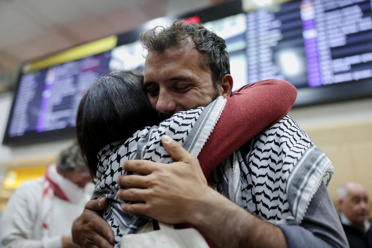 Brazilian activist Thiago Avila, who was detained aboard the Gaza-bound Global Sumud Flotilla, which was intercepted by Israeli forces, is embraced as he arrives at Sao Paulo/Guarulhos International Airport after being deported, in Guarulhos, Brazil, May 11, 2026. REUTERS/Amanda Perobelli