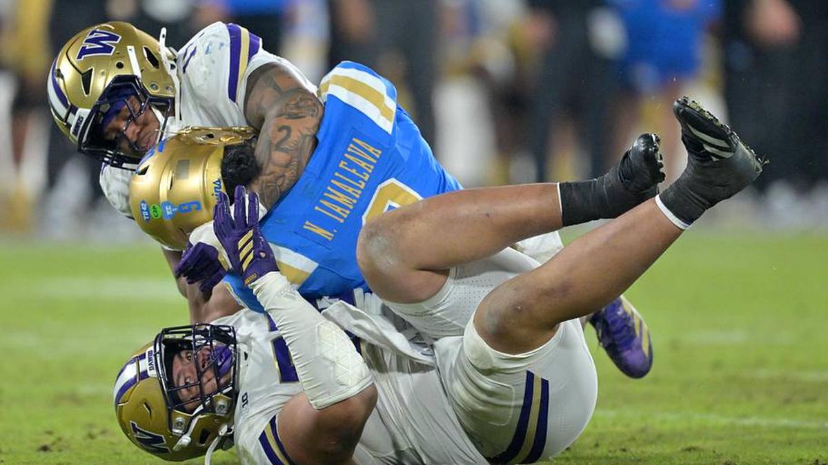  Nov 22, 2025; Pasadena, California, USA; UCLA Bruins quarterback Nico Iamaleava (9) is sacked by Washington Huskies linebacker Deven Bryant (17) and defensive lineman Bryce Butler (92) during the second half at the Rose Bowl. Mandatory Credit: Jayne Kamin-Oncea-Imagn Images | Jayne Kamin-Oncea-Imagn Images 