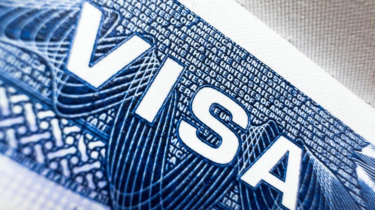 US visa, Visa in passport, fee for US visa, tour of the USA, airport, customs, checkpoint, illegal immigrants, closed borders, nationality H-1B visa. Macro photo. A close-up shot of a U.S. visa. Image for illustration purposes only. 