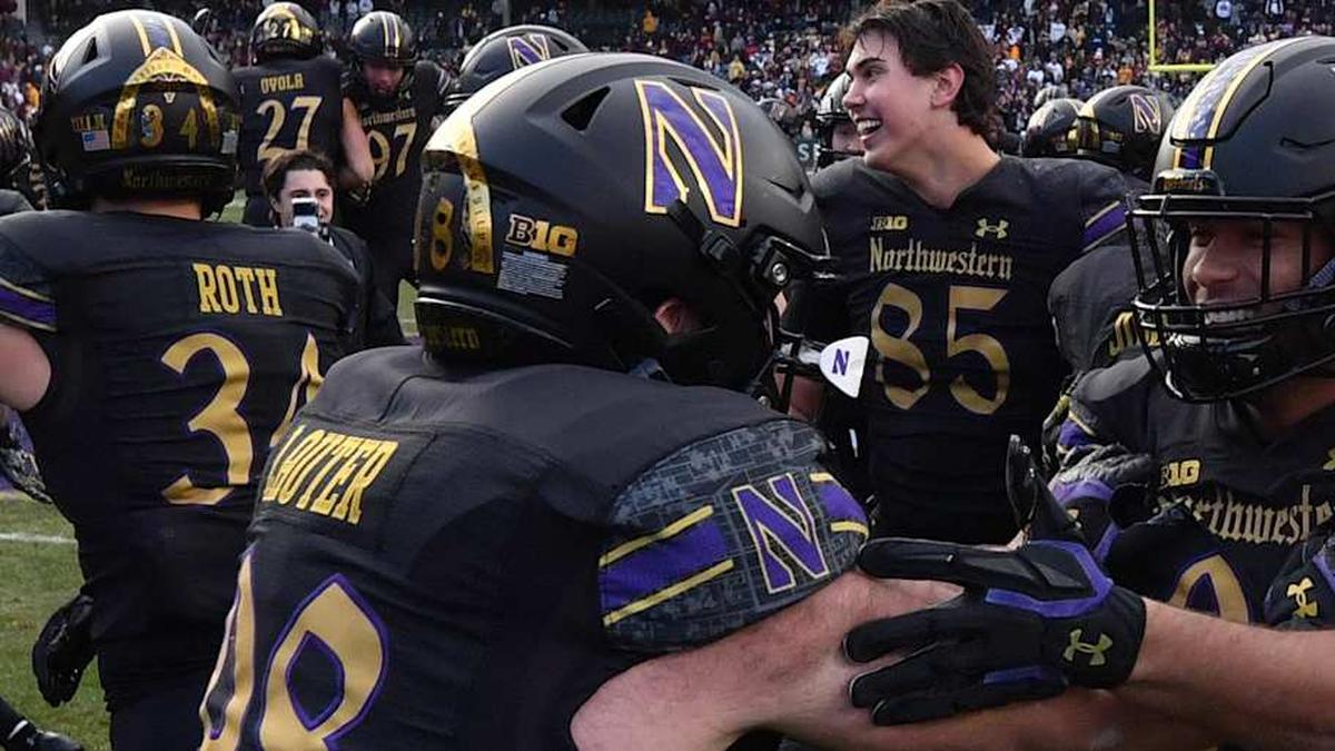  Nov 22, 2025; Chicago, Illinois, USA; The Northwestern Wildcats celebrate after winning the game against the Minnesota Golden Gophers at Wrigley Field. Mandatory Credit: Patrick Gorski-Imagn Images | Patrick Gorski-Imagn Images 