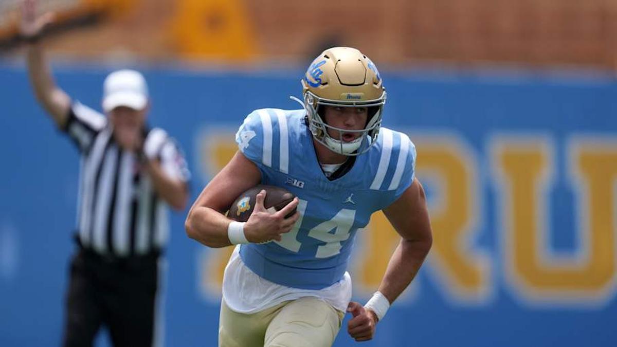  May 2, 2026; Pasadena, CA, USA; UCLA Bruins quarterback y Dieffenbach (14) carries the ball during the spring game at Rose Bowl. Mandatory Credit: Kirby Lee-Imagn Images | Kirby Lee-Imagn Images 