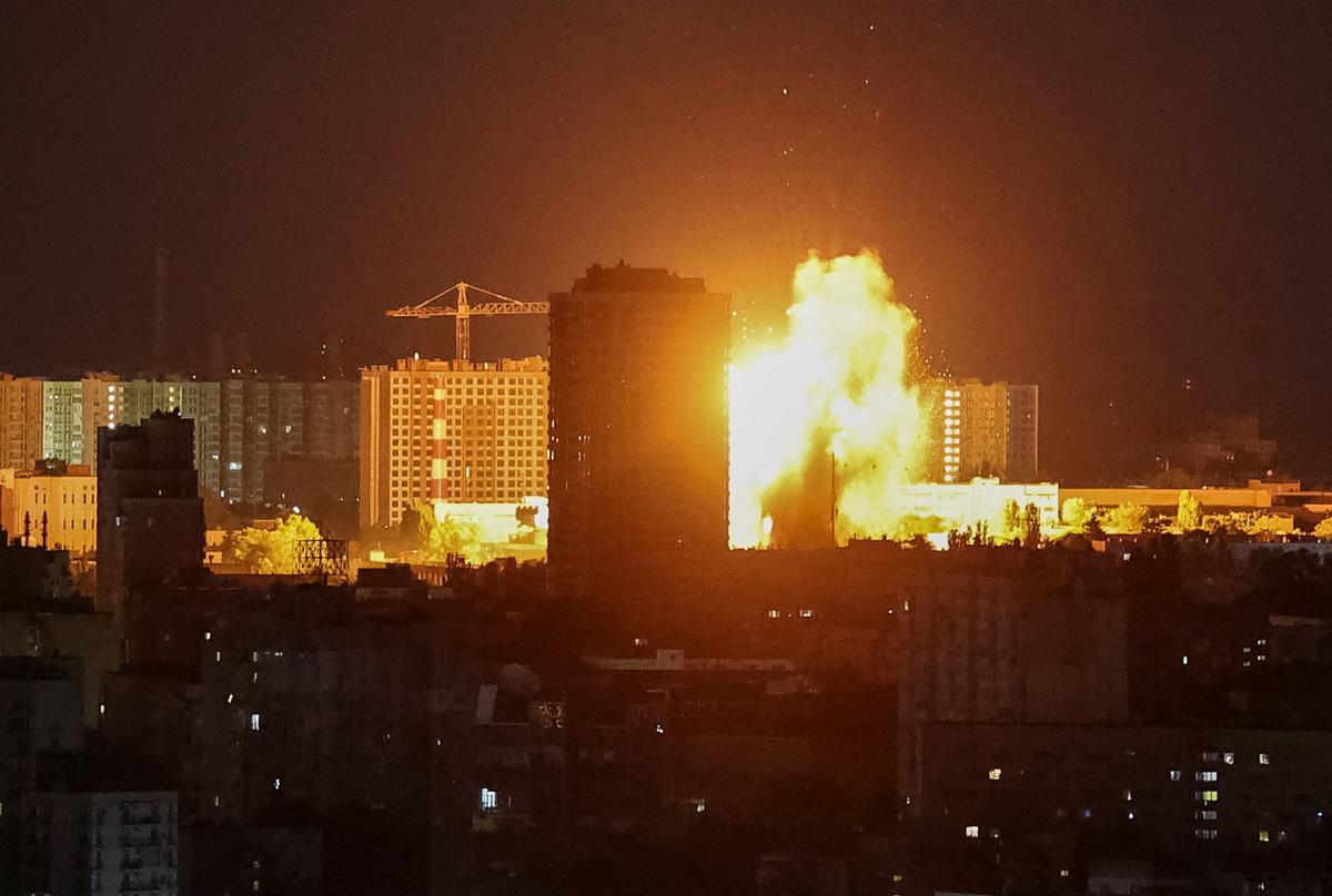 An explosion lights up the sky over the city during a Russian missile and drone strike, amid Russia's attack on Ukraine, in Kyiv, Ukraine June 2, 2026. REUTERS/Gleb Garanich
